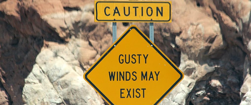 signpost saying gusty winds may exist